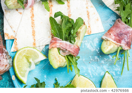 Avocado wrapped in parma ham and rocked salad Avocado wrapped in parma ham and rocked salad 42976986