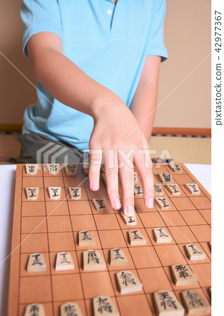 Children playing shogi Children playing shogi 42977367