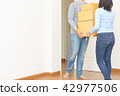 Couple holding boxes and walking together 42977506