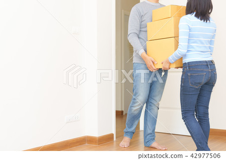 Couple holding boxes and walking together Couple holding boxes and walking together 42977506