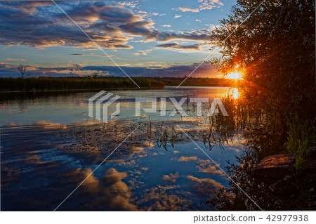 Beautiful sunset over the river. Beautiful sunset over the river. 42977938