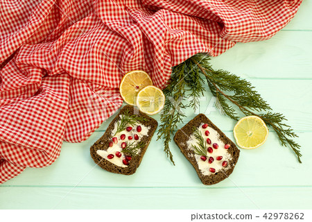 Black bread with grenades berries on turquoise  42978262