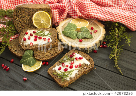 Black bread with grenades berries on a black  42978286