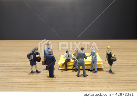 a mini figure of Business standing with team. a mini figure of Business standing with team. 42978381