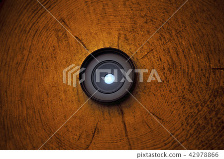 Small Photo Lens wooden background  42978866