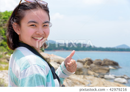 Young woman photography near the sea Young woman photography near the sea 42979216
