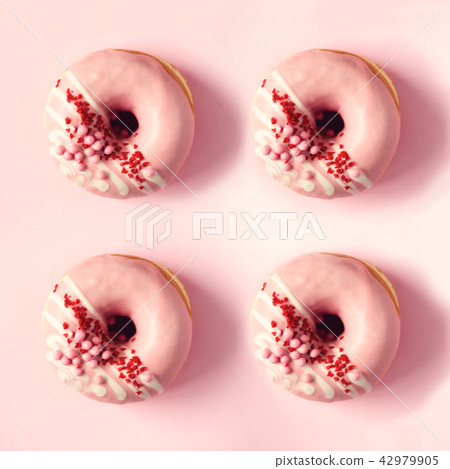 Square crop of sweet doughnut with pink icing on Square crop of sweet doughnut with pink icing on 42979905