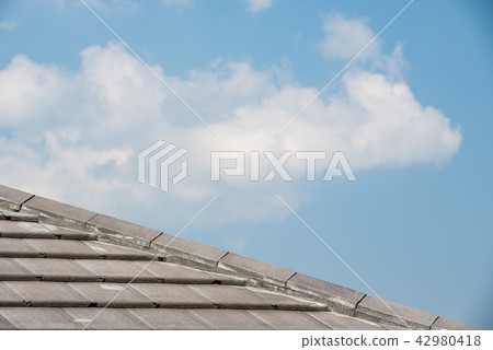 roof tiles with blue sky background roof tiles with blue sky background 42980418