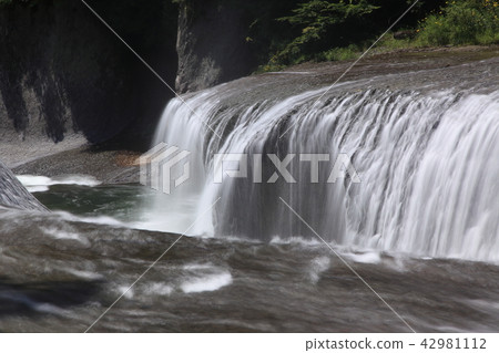 A slowly falling waterfall A slowly falling waterfall 42981112