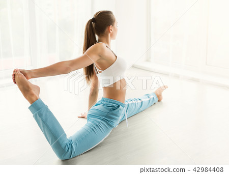 Plastic female dancer doing splits at gym center 42984408