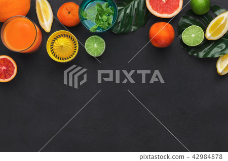 Citrus fruits and glass of fresh juice 42984878