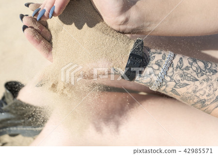 Sand flows from the hand Sand flows from the hand 42985571