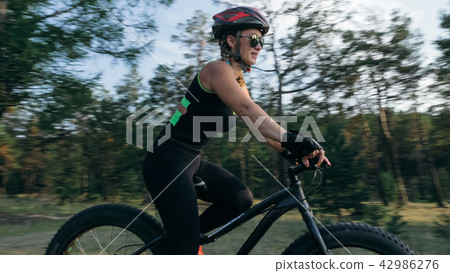 Fat bike also called fatbike or fat-tire bike in summer riding in the forest. Fat bike also called fatbike or fat-tire bike in summer riding in the forest. 42986276