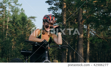 Fat bike also called fatbike or fat-tire bike in summer riding in the forest. 42986277