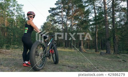Fat bike also called fatbike or fat-tire bike in summer riding in the forest. Fat bike also called fatbike or fat-tire bike in summer riding in the forest. 42986279