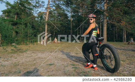 Fat bike also called fatbike or fat-tire bike in summer riding in the forest. 42986280
