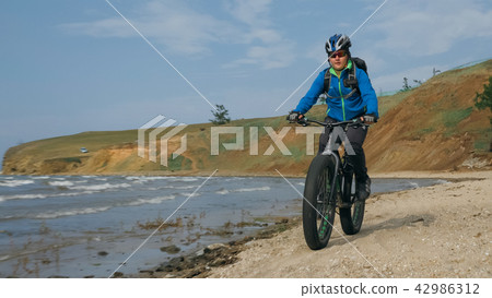Fat bike also called fatbike or fat-tire bike in summer driving on the beach. 42986312