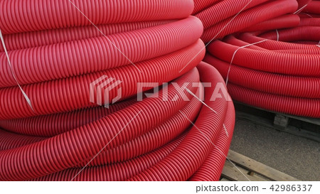 Warehouse of finished plastic pipes industrial outdoors storage site. Manufacture of plastic water 42986337