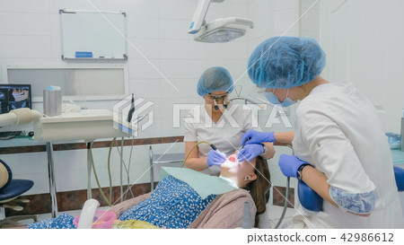 Woman at dentist clinic gets dental treatment to fill a cavity in a tooth. Dental restoration and 42986612