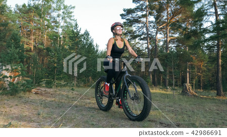 Fat bike also called fatbike or fat-tire bike in summer riding in the forest. 42986691