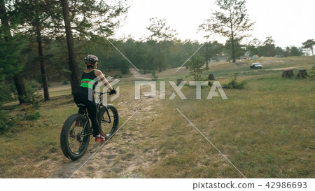 Fat bike also called fatbike or fat-tire bike in summer riding in the forest. 42986693