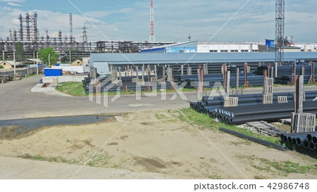 Warehouse of finished plastic pipes industrial outdoors storage site. Manufacture of plastic water 42986748