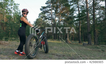 Fat bike also called fatbike or fat-tire bike in summer riding in the forest. Fat bike also called fatbike or fat-tire bike in summer riding in the forest. 42986985