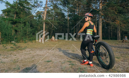 Fat bike also called fatbike or fat-tire bike in summer riding in the forest. 42986986