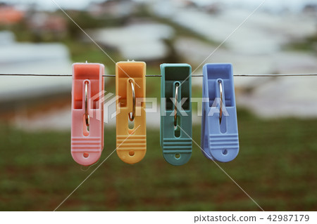 Colorful plastic clothes pegs 42987179