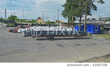 Warehouse of finished plastic pipes industrial outdoors storage site. Manufacture of plastic water 42987206