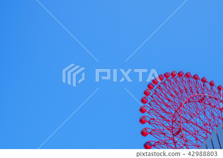 blue sky and red ferris wheel 42988803