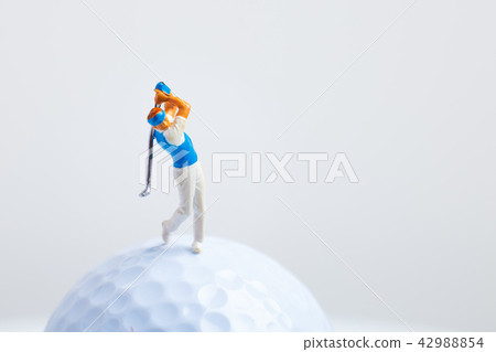 Golf ball and miniature human Golf ball and miniature human 42988854