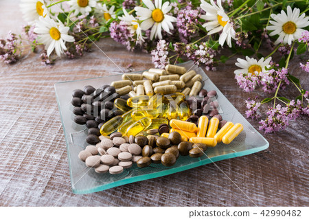 Ayurvedic pills with chamomile and tansy flowers Ayurvedic pills with chamomile and tansy flowers 42990482