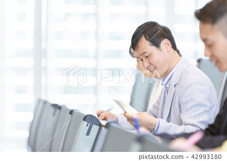 Businessman seminar taking qualification examination qualification examination office casual business scene 42993180