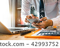 close up of businessman working with smart phone close up of businessman working with smart phone 42993752