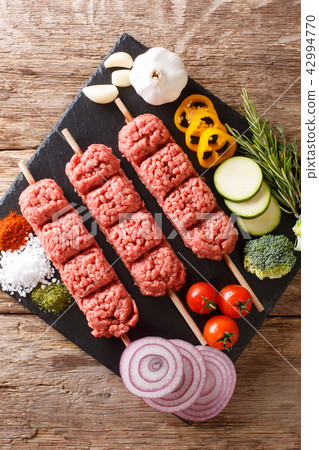 Homemade kebabs from raw minced meat Homemade kebabs from raw minced meat 42994770