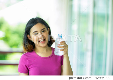 Young asian woman holding a bottle of water 42995920