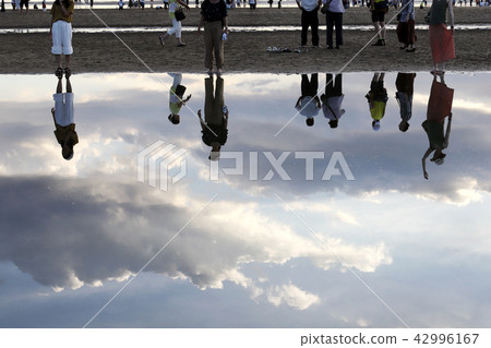 Sandy person reflection 42996167