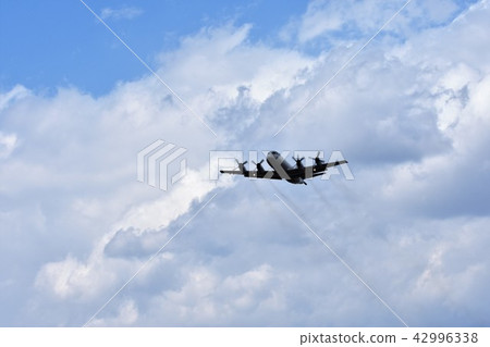 Maritime Self Defense Force patrol aircraft flying under a huge cumulonimbus cloud 42996338