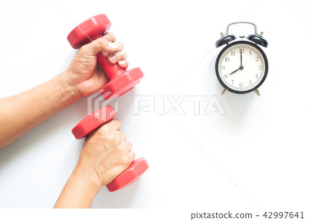 Man's hands holding dumbbells, Muscular build. 42997641