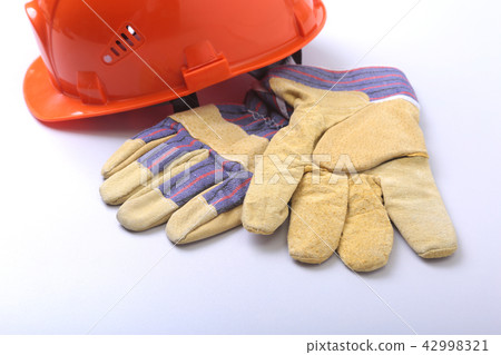 Orange hard hat, protective mask, safety gloves 42998321