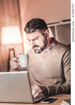 High spirited man working at home High spirited man working at home 42998797