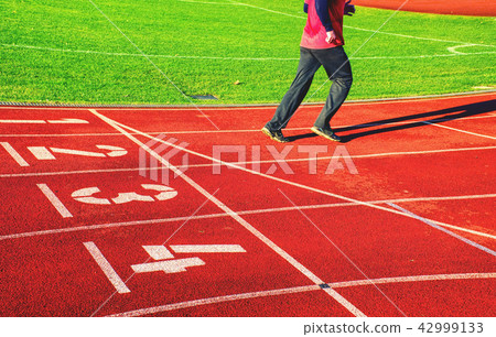 Running legs and shadow of a male athlete running 42999133
