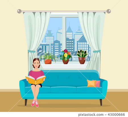 Young woman relaxing on sofa reading book at home 43000666