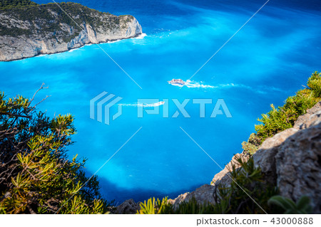 Navagio beach, Zakynthos, Greece. Tourist trip boats visiting and leaving Shipwreck bay with 43000888
