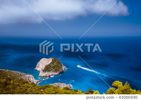 Zakynthos fantastic coastal view with white cliff. White tourist ship sailing full speed on open 43000890