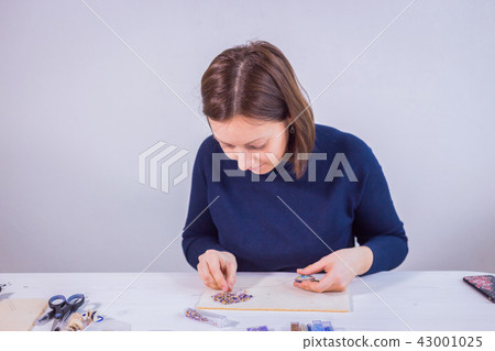 Designer making handmade brooch Designer making handmade brooch 43001025