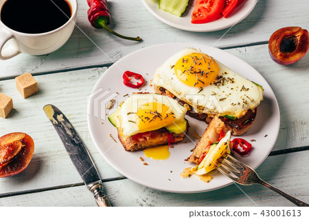 Sandwiches with vegetables and fried egg and cup of coffee Sandwiches with vegetables and fried egg and cup of coffee 43001613