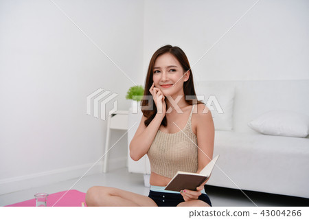 The concept of weight loss. Asian girls are looking for knowledg 43004266