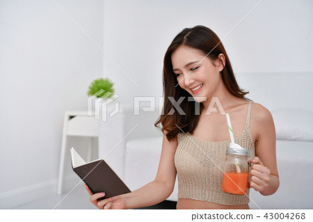 The concept of weight loss. Asian girls are looking for knowledg 43004268